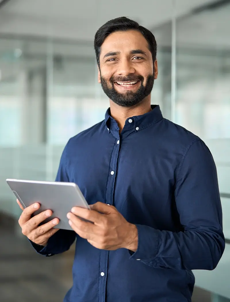 happy-indian-businessman-using-tab-working-standin-HQRPYEE